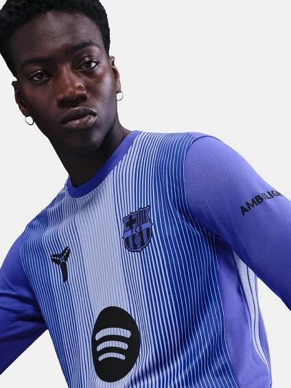 FC Barcelona away jersey in white with vertical blue stripes, purple sleeves, and black details, featuring the Barça crest, Nike logo, Spotify sponsor, and AMBILIGHT branding on the sleeve