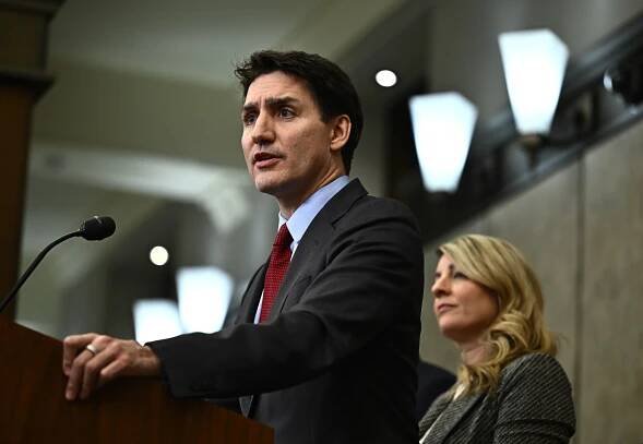 Canadian Prime Minister Justin Trudeau addresses media members after U.S. President Trump signed an order to impose stiff tariffs