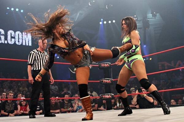 Mickie James delivers a spinning back kick to Sarita - Photo courtesy of Lee South and TNA Entertainment LLC.jpg