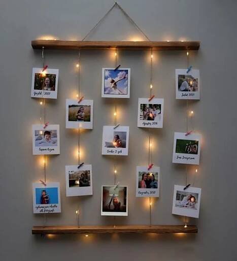 a wall hanging with pictures and lights on it