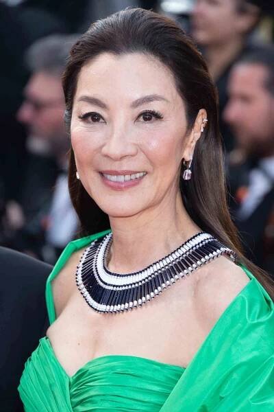 Michelle Yeoh with a youthful hairstyle for over 40, long, straight, swept-back hair