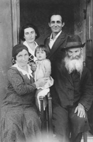 A Jewish family poses for a family photograph outside its home on the eve of Shavuot.

The woman on the left is Ryfka, the sister of Joseph Mordechai Halter.