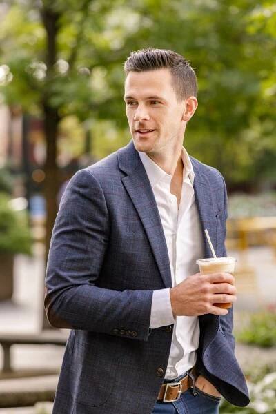 A man walking with an iced coffee