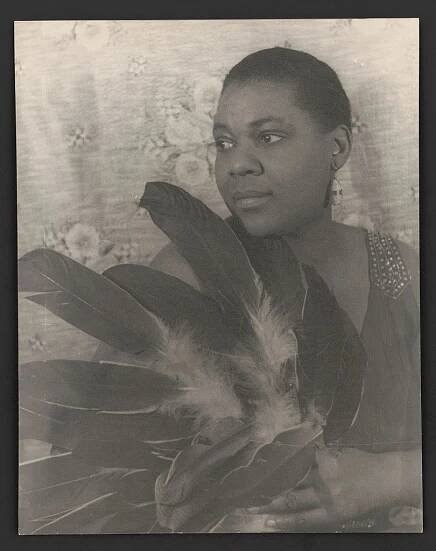 [Portrait of Bessie Smith holding feathers]