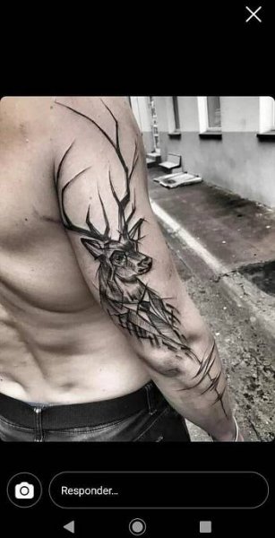 a man with a deer tattoo on his arm and chest is looking at the camera