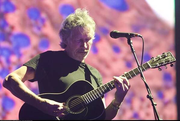 Roger Waters strums guitar at Coachella