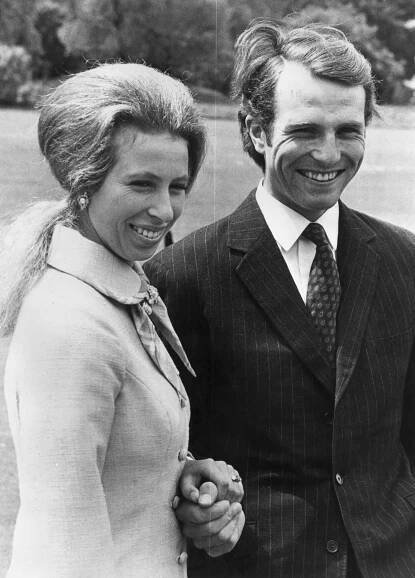 princess anne and lieutenant mark phillips smiling and looking off to the side outside
