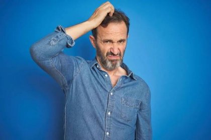 man scratching his head trying to make sense of a backhanded compliment