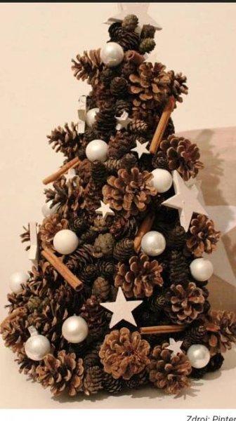 a christmas tree made out of pine cones and white balls