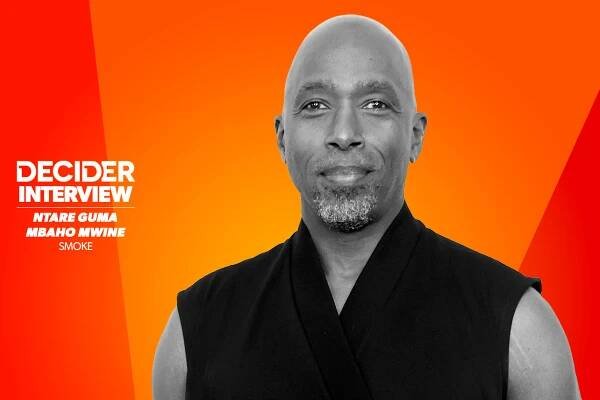 NTARE GUMA MBAHO MWINE in black and white on an orange background