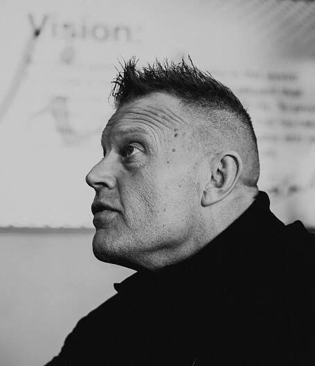a black and white portrait photo of Todd Smith, wearing a black turtleneck shirt
