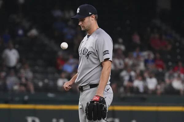 New York Yankees pitcher Jake Bird tosses the baseball game ball during the 10th inning against the Texas Rangers, Monday, Aug. 4, 2025, in Arlington, Texas. 