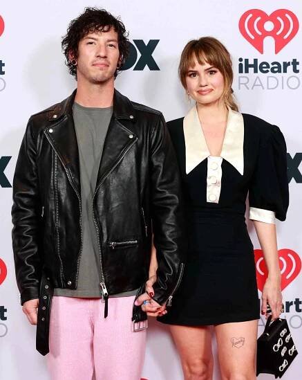 Josh Dun and Debby Ryan attend the 2021 iHeartRadio Music Awards at The Dolby Theatre in Los Angeles, California
