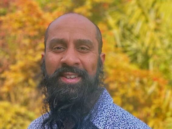 headshot of Sunil Patel with golden foliage in the background