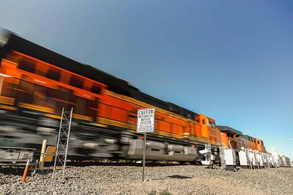 A BNSF train passes by wayside detectors.