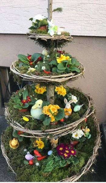 three tiered planter made out of branches and flowers