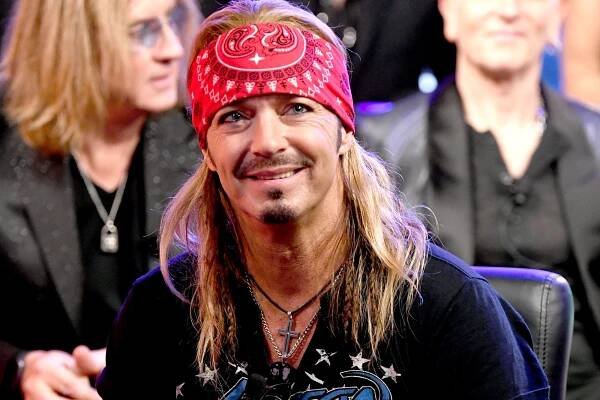 Bret Michaels smiling while wearing a red bandana.